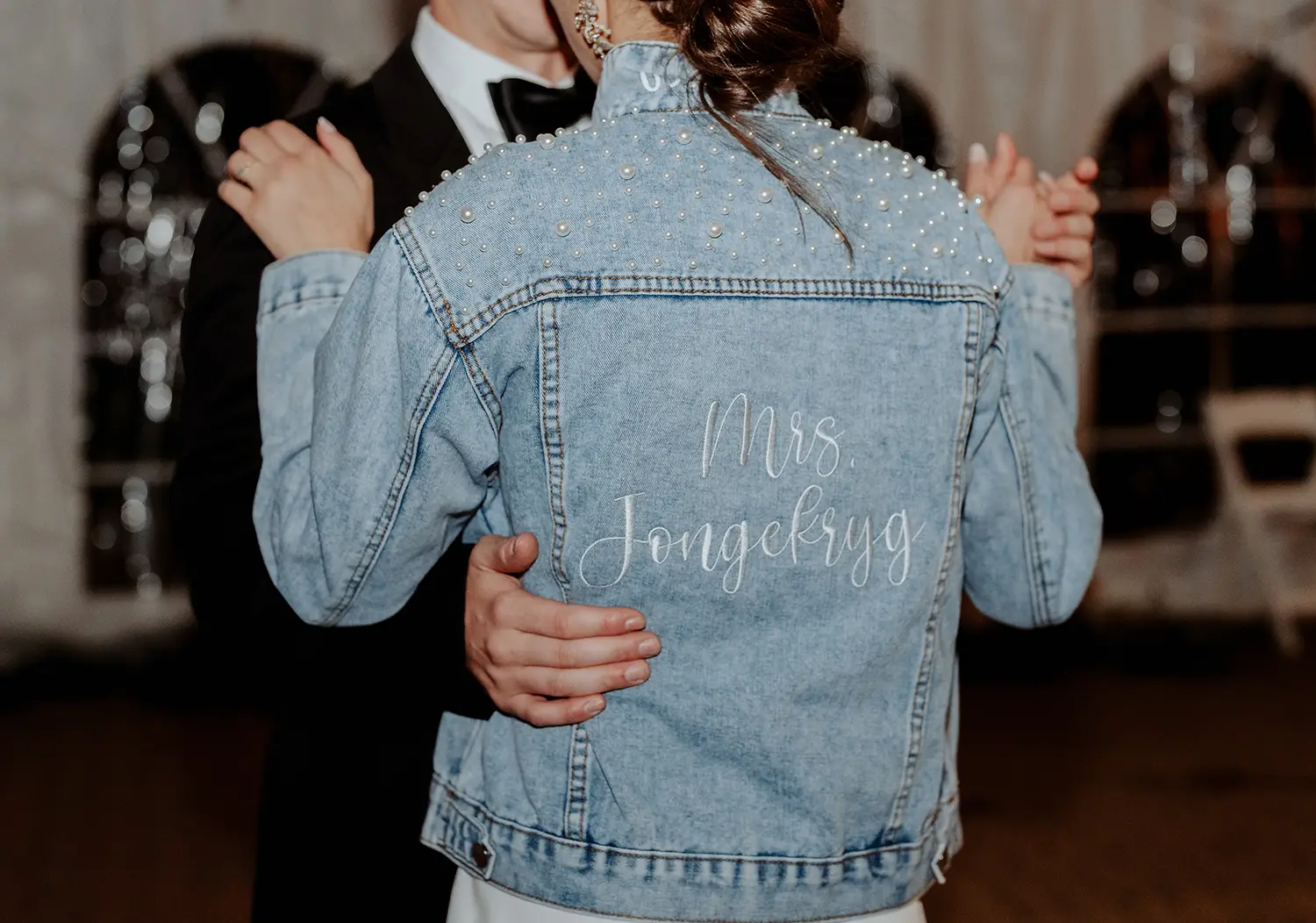 Wedding dance of couple with bride who has a Denim jack with Mrs jongekrygs embroidered 
