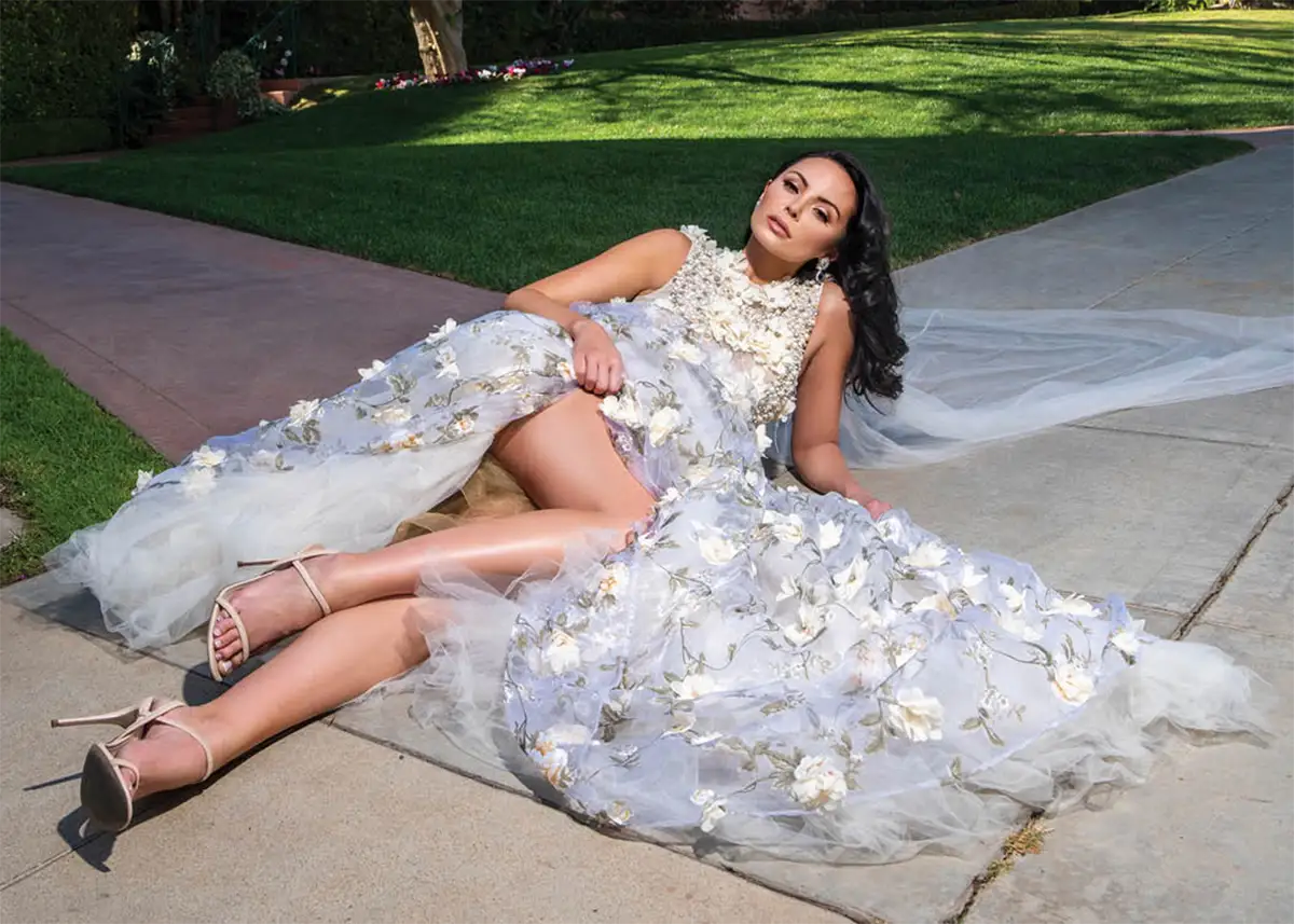 woman lays down in detailed wedding dress