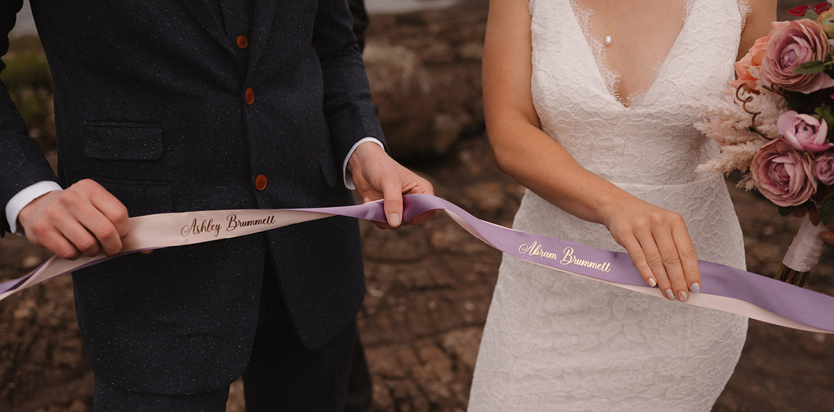 Ashley and Abe holding purple ribbon 