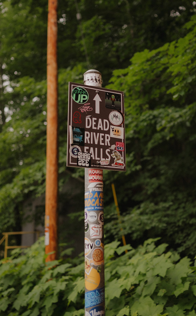 Dead River Falls signpost covered in stickers