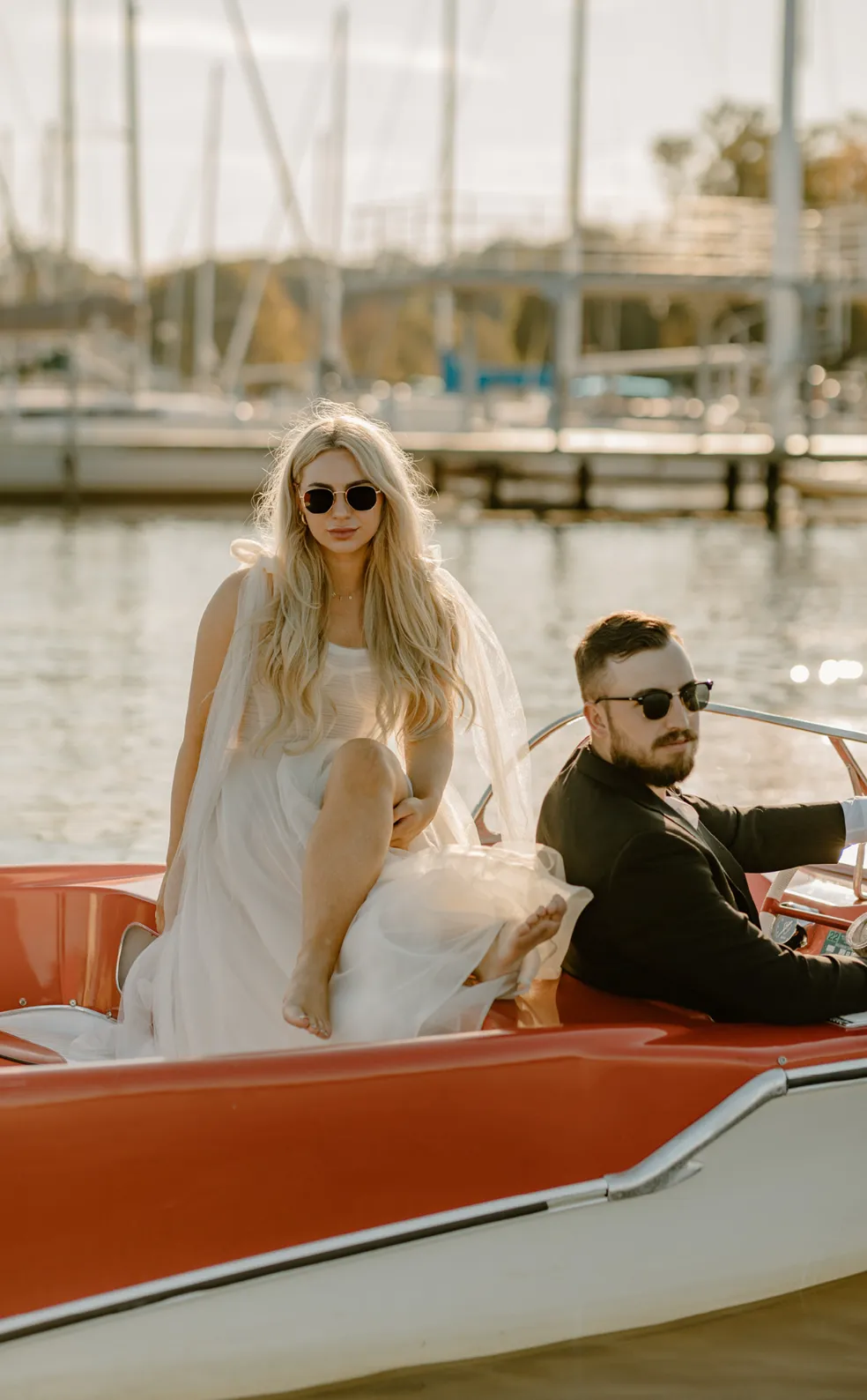 Chloe and Brandon posing with glasses on a boat