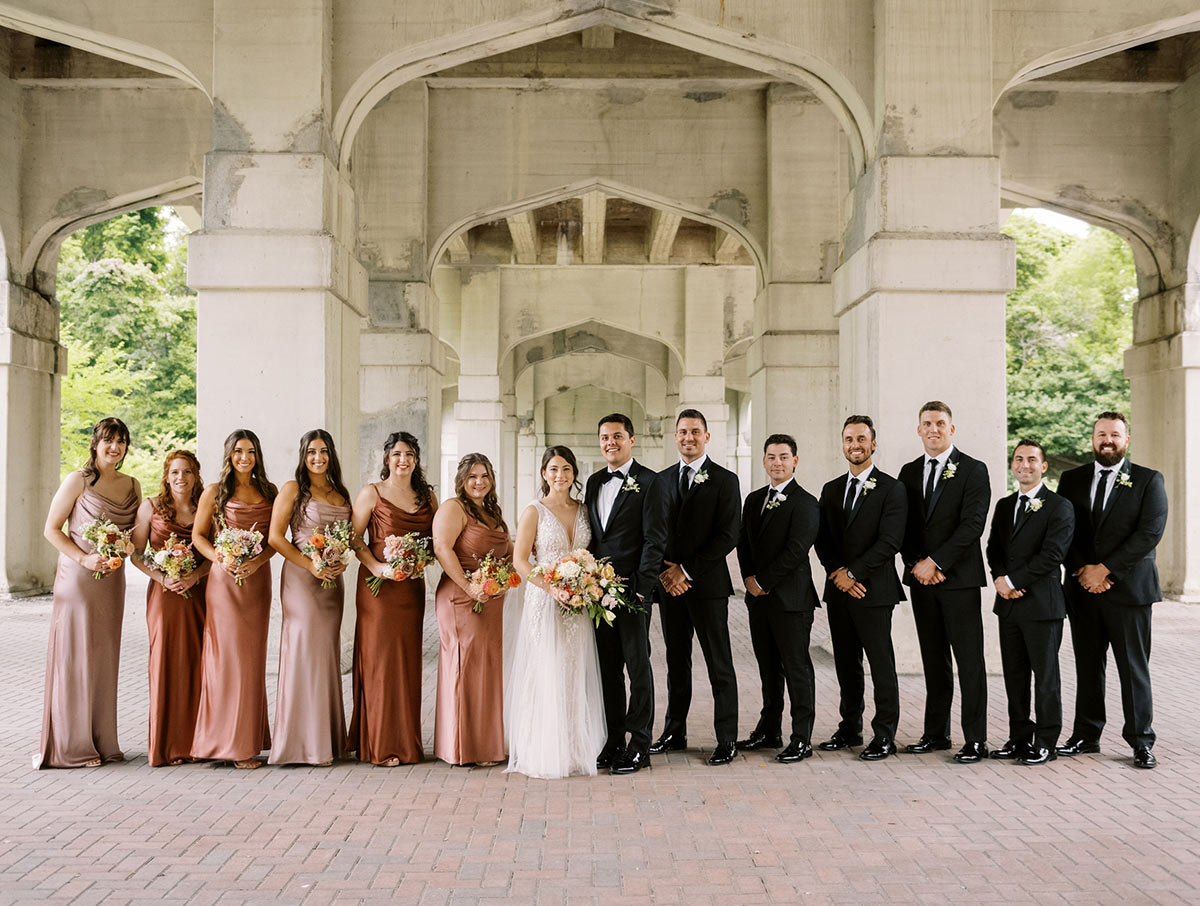 Miranda and Alex with bridesmaids and groomsmen outside