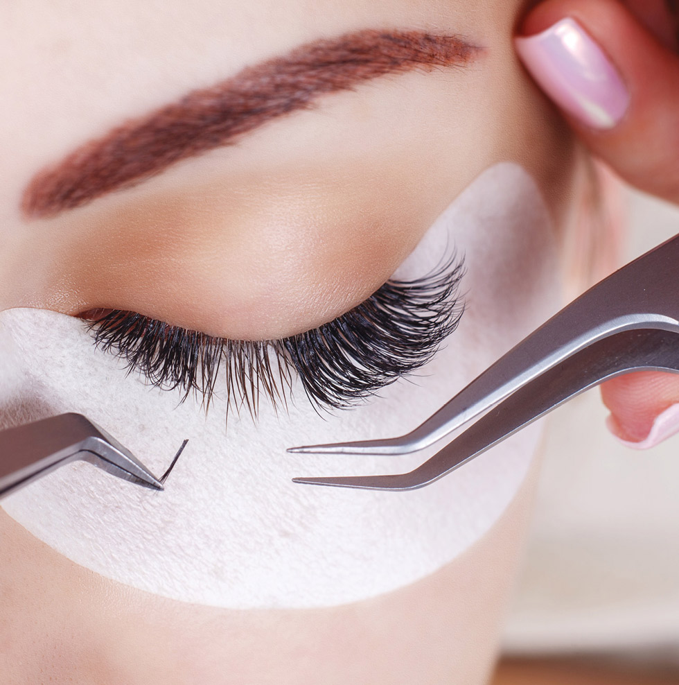 close up of eyelashes being worked on in a salon