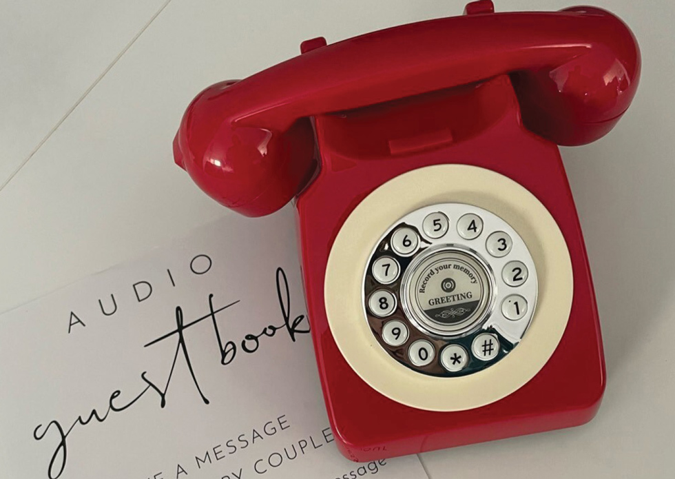 old red telephone being used as an audio guest book for a wedding