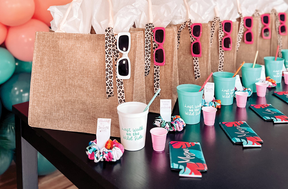 bridal gift bags that include sunglasses, custom cups with straws, scrunchies, and drink holders