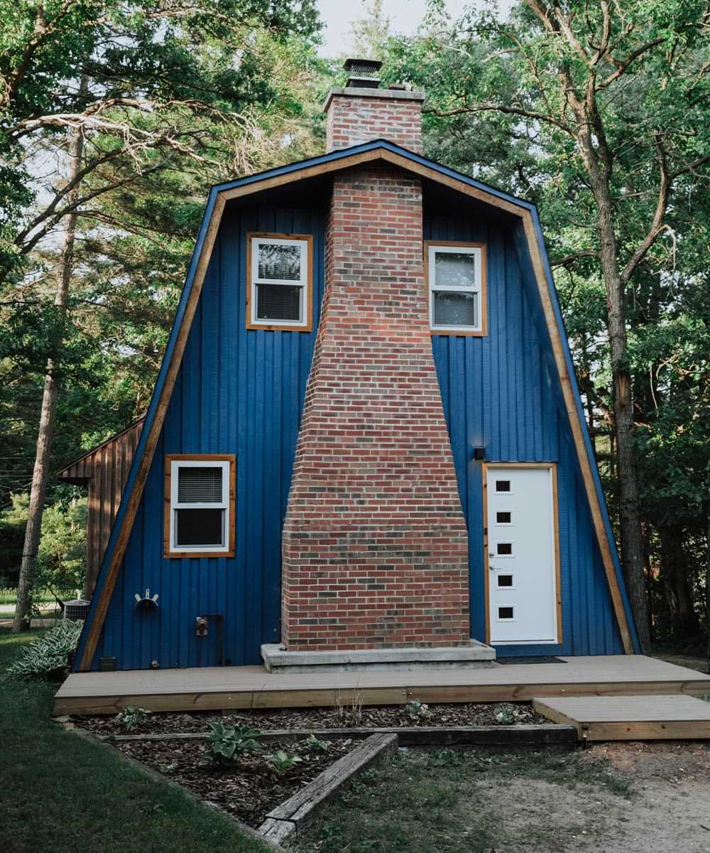 front view of the blue painted and red brick chimney Dell Prairie A-Frame Chalet