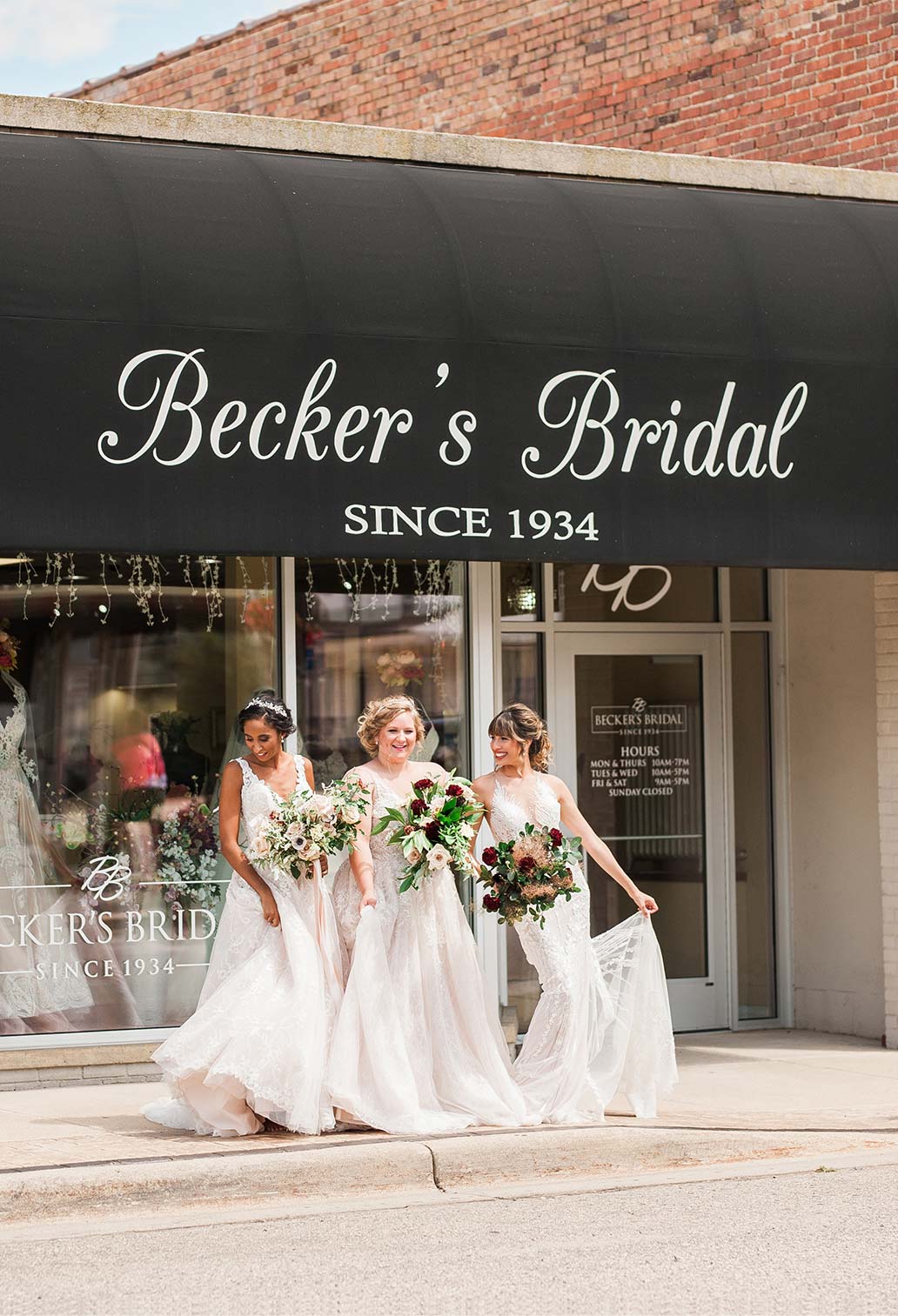 3 brides taking a picture outside Becker's Bridal shop