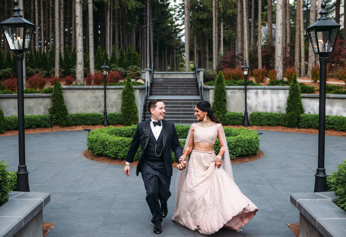 bride and groom smiling walking in courtyard