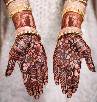 bride's hands covered in henna