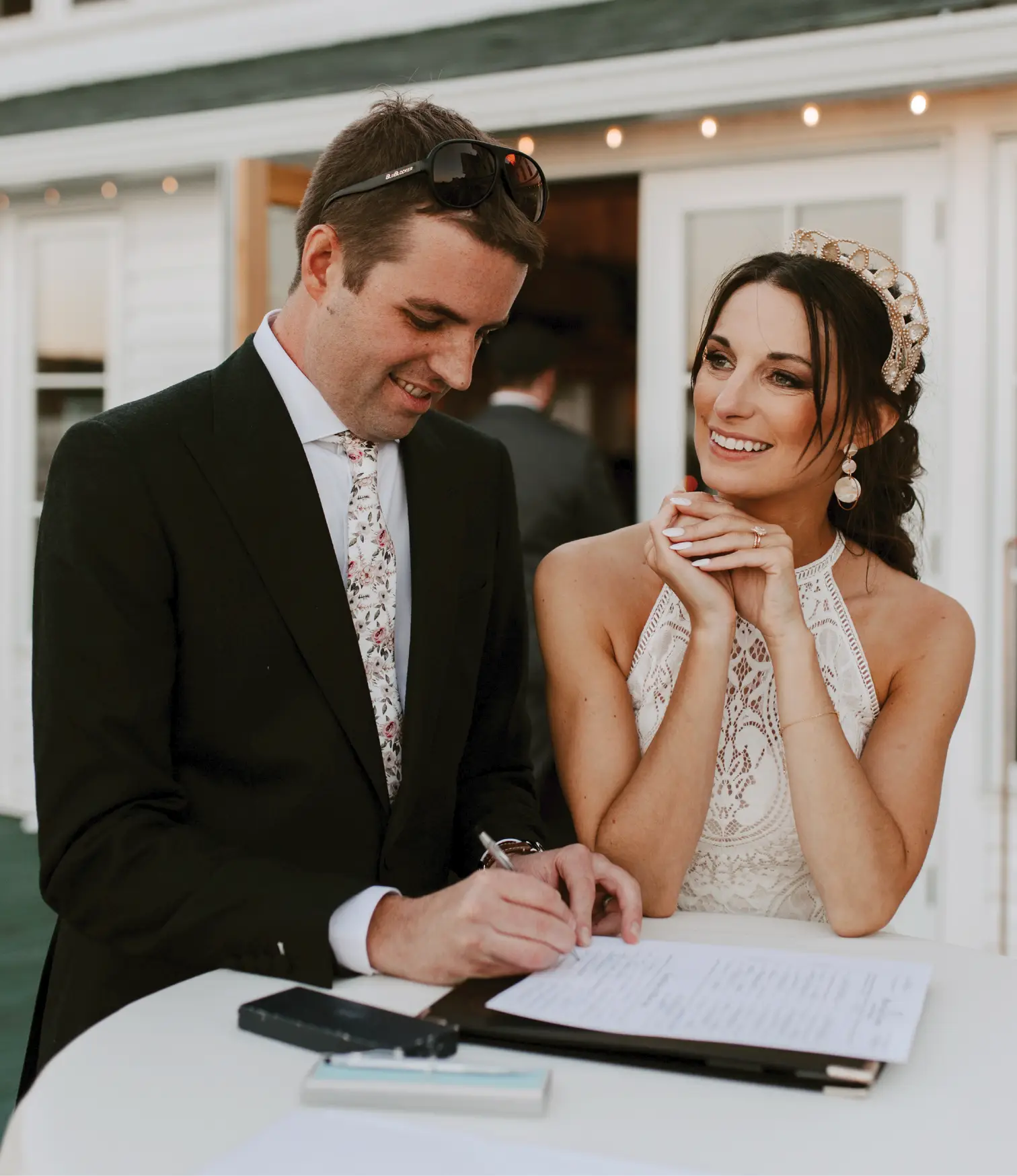 Married couple smiling and signing marriage license