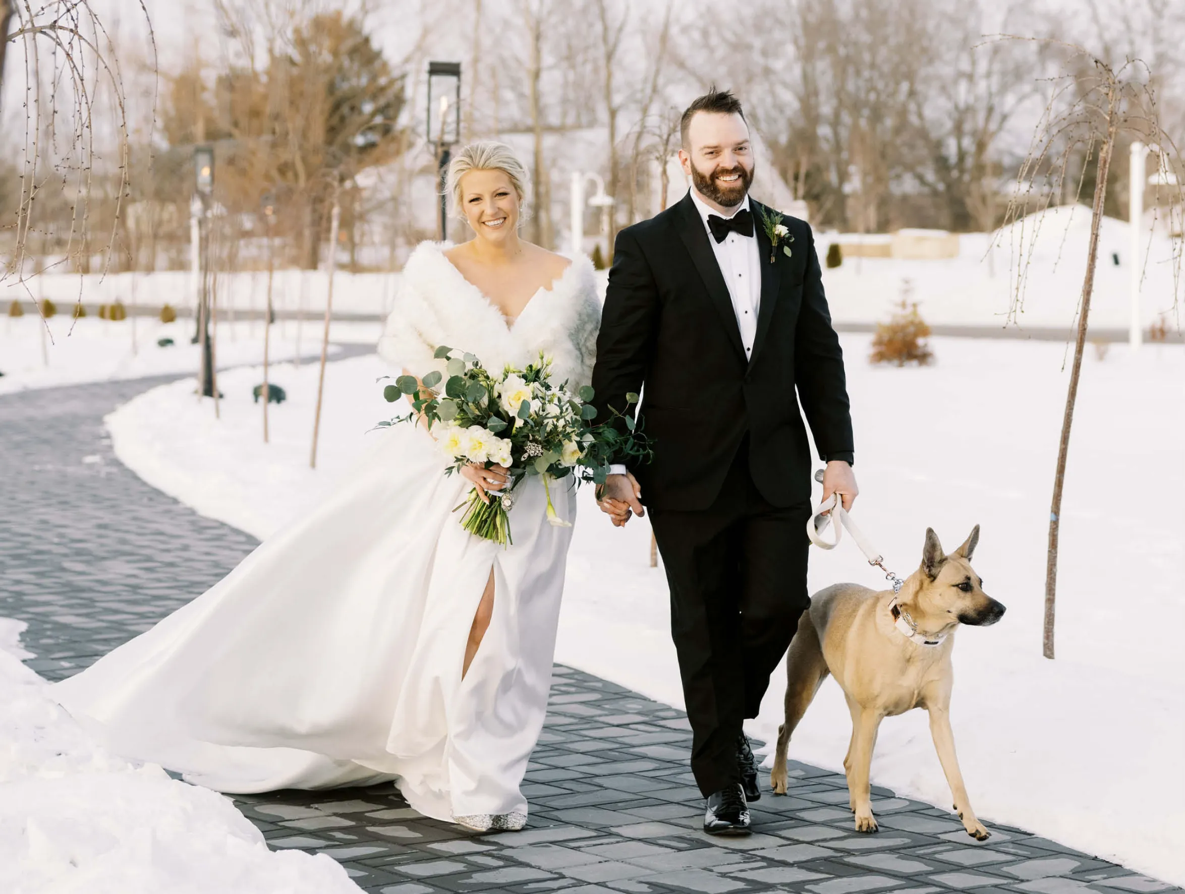 bride and groom walking with their dog