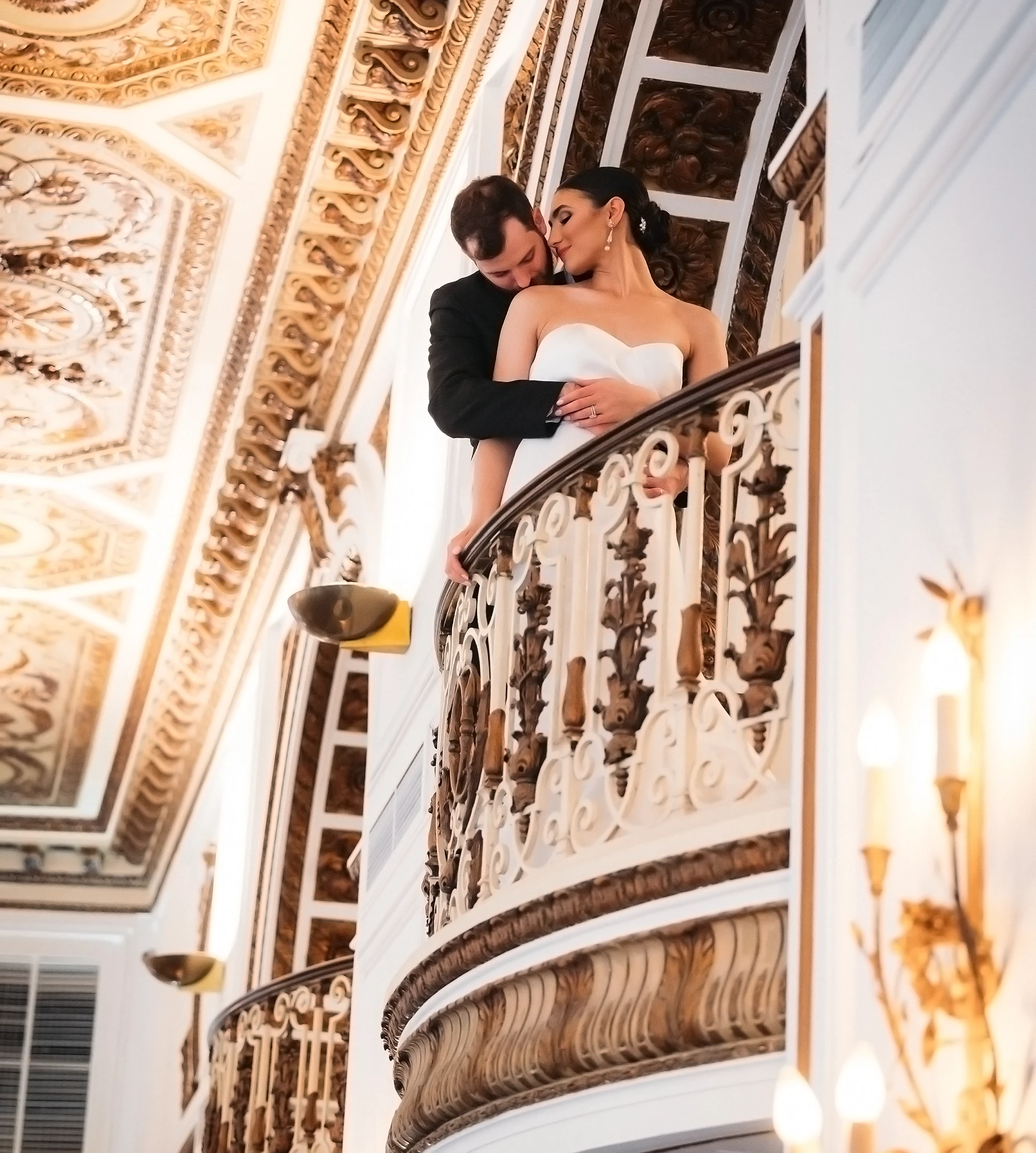 katrina and sean embracing on an ornate balcony