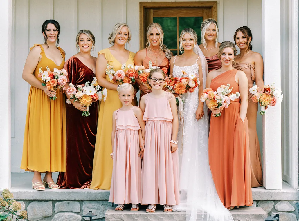 Bridal party with bridesmaids in different color dresses