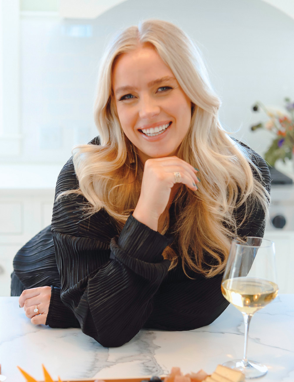 woman smiling with a glass of wine