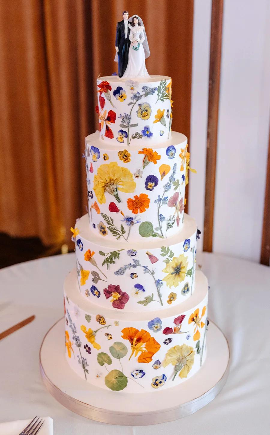 four tier wedding cake with flower designs