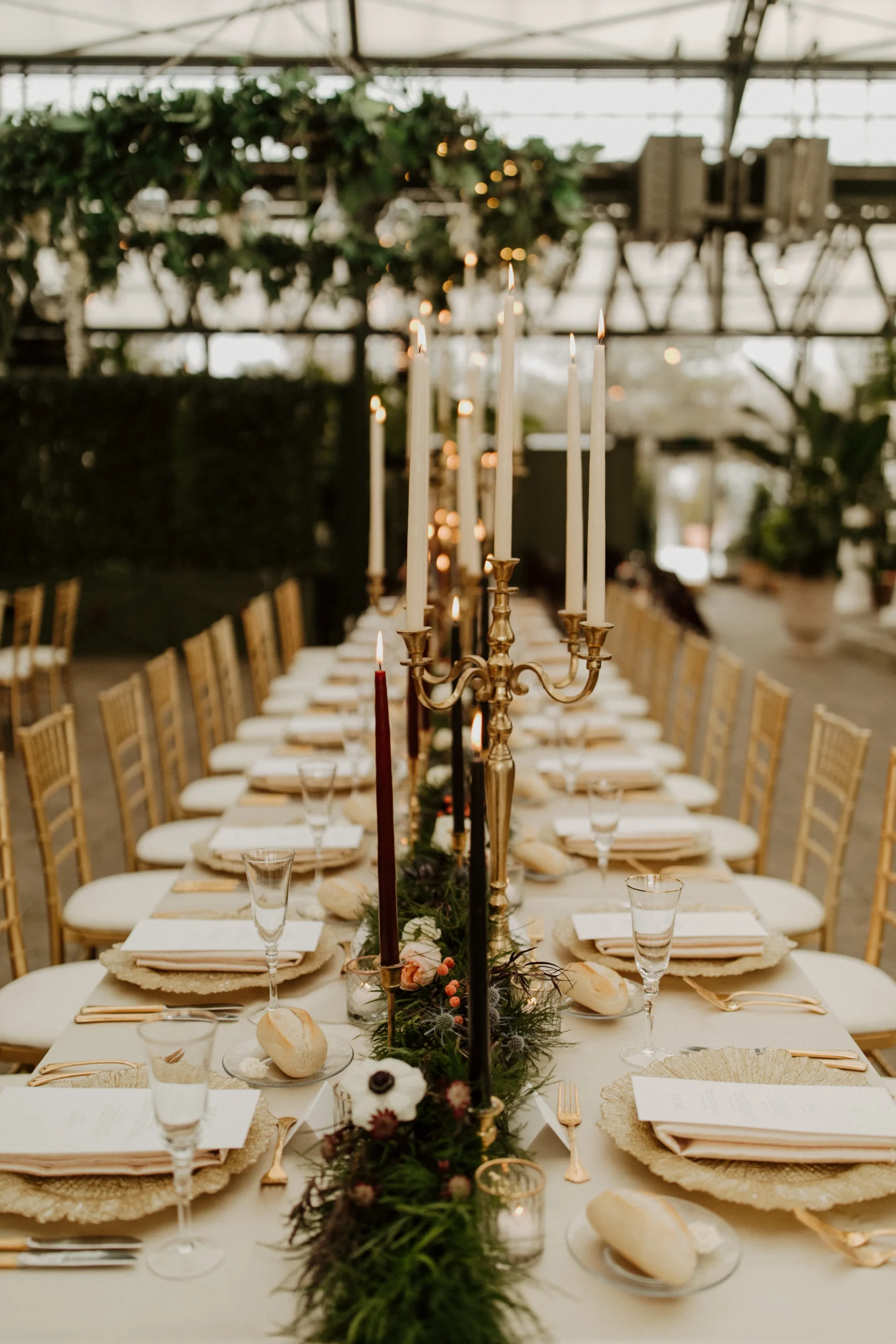 table arrangement with candles and greenery