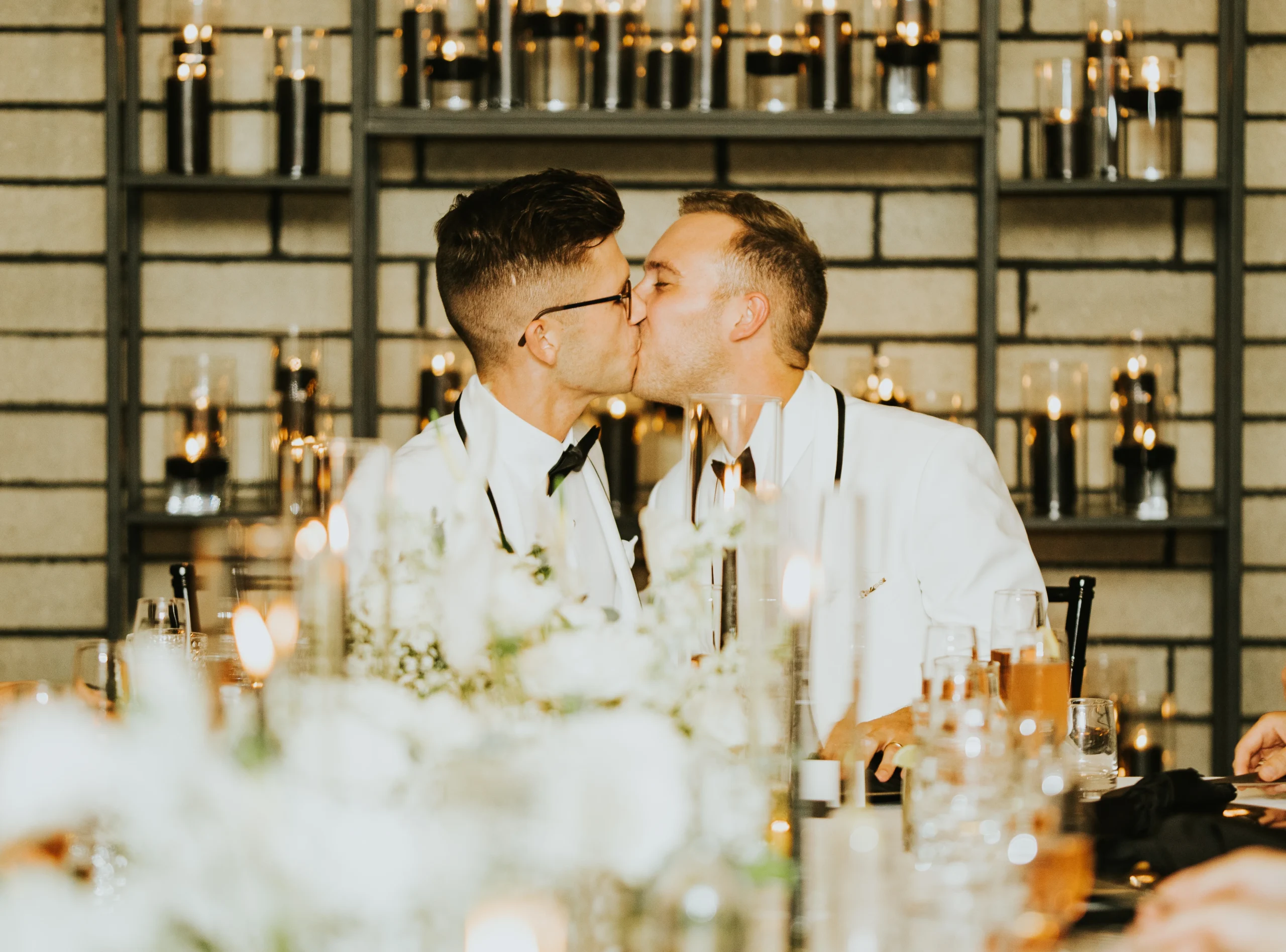 a couple kissing at a table 