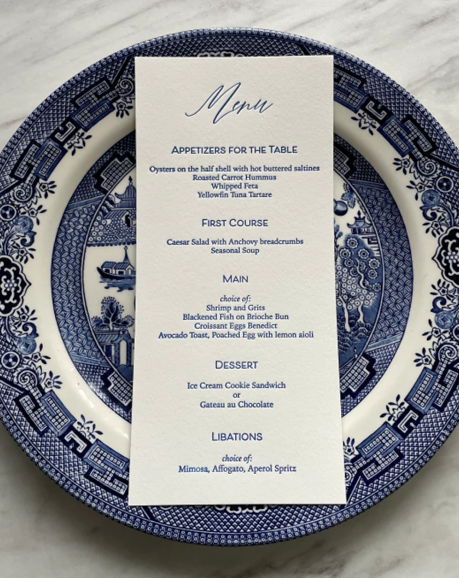 wedding invitations on blue and white plate