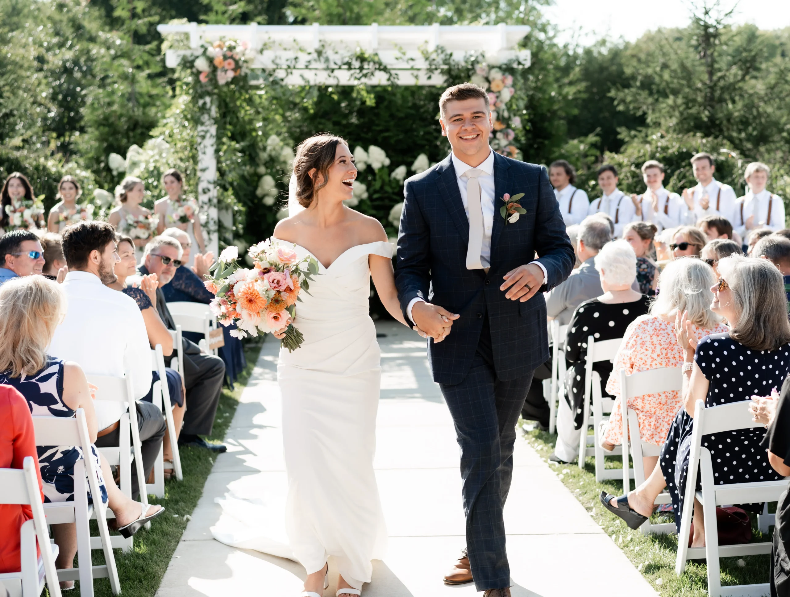 bride and groom smiling and walking down aisle after ceremony 