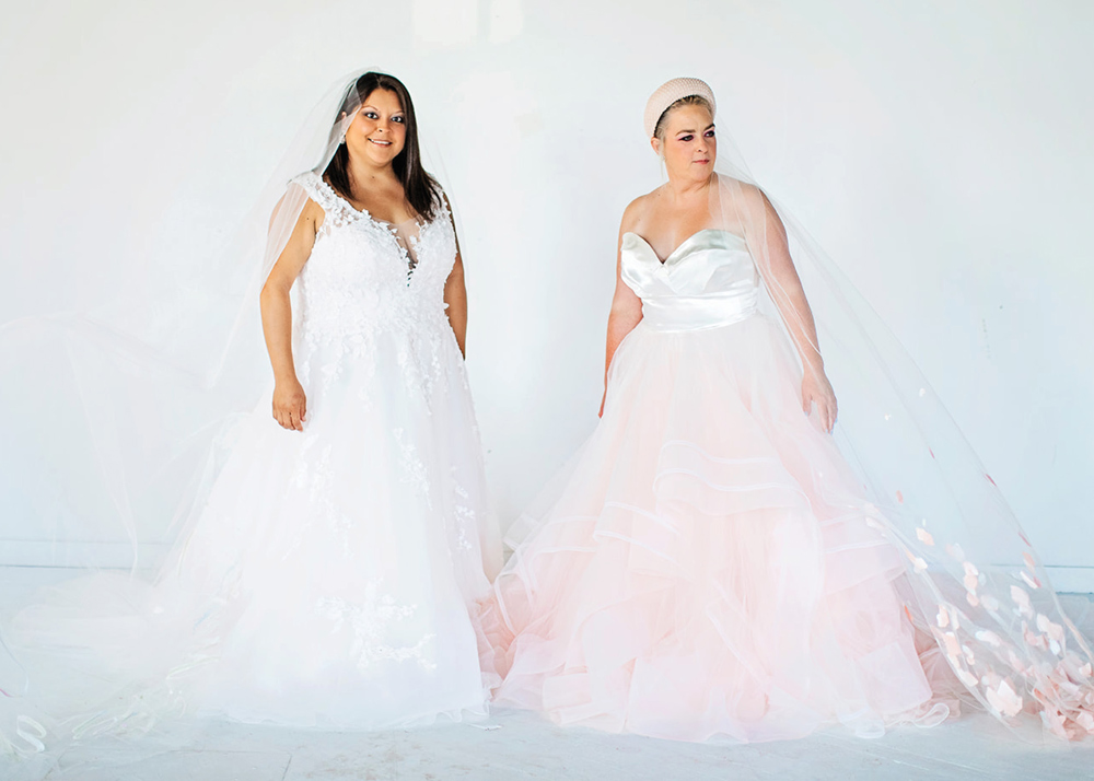 two women in bridal dresses
