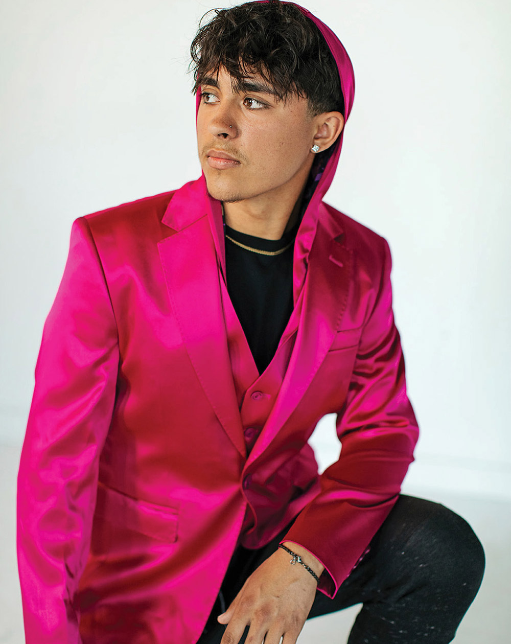 man in a pink dress suit jacket with a hood