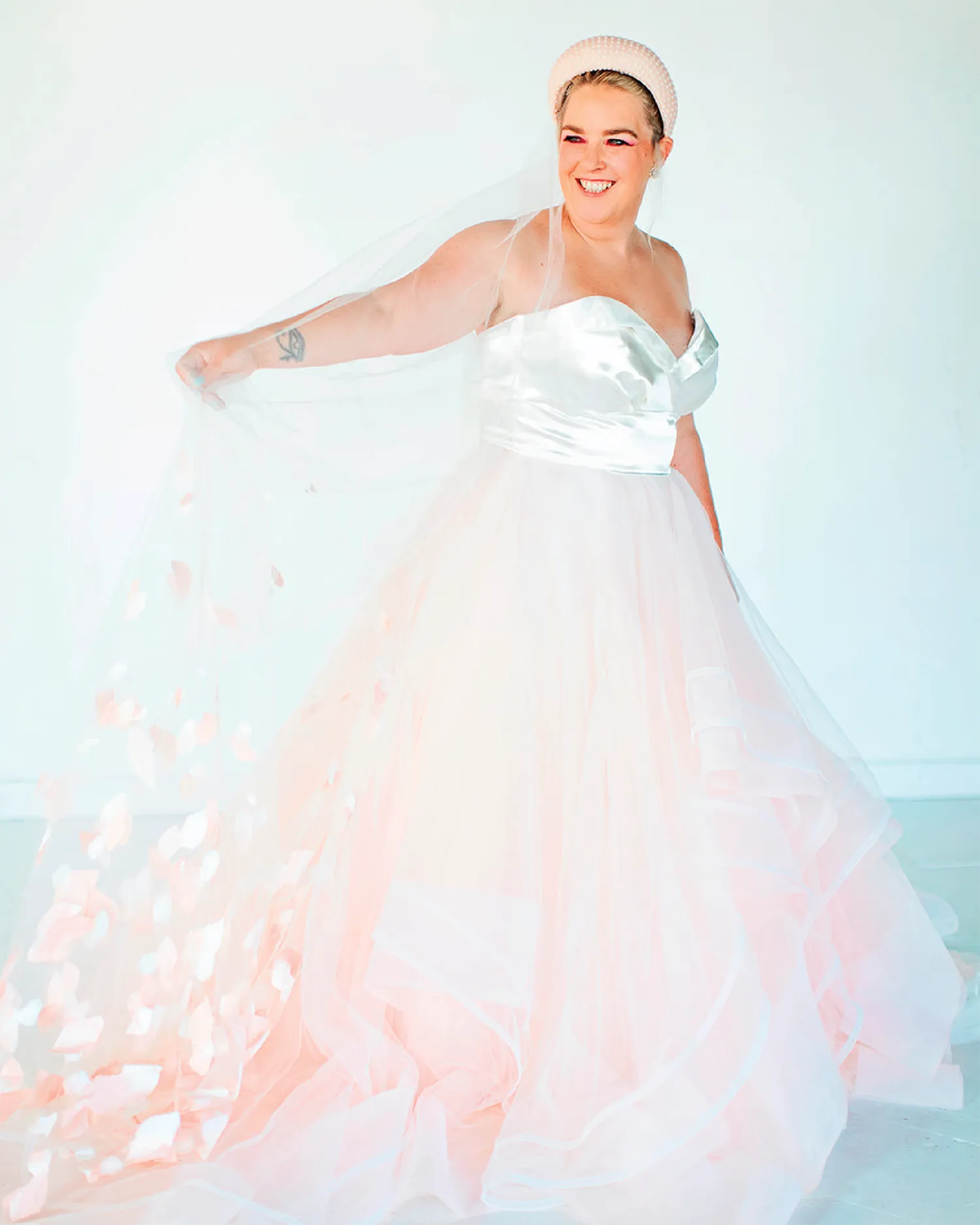 woman smiling and wearing colorful wedding dress